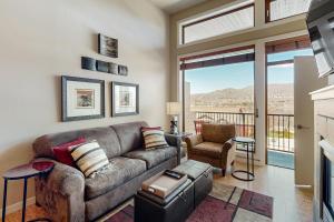 a living room with a couch and a window at Chelan Resort Suites in Chelan