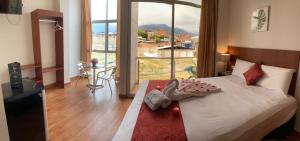 a hotel room with a bed with a large window at HOTEL LA PALMERA DE ORO in Tarapoto