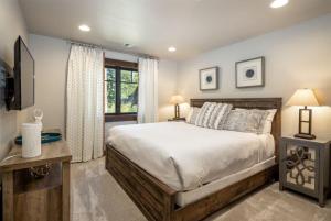 a bedroom with a large bed and a television at Suncadia 4 Bdrm Home Beautiful Floor to Ceiling Fireplace in Cle Elum +34 photos