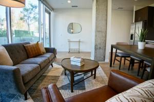 a living room with a couch and a table at Nimitz Crossing Luxury Residences in San Diego