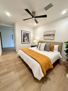 a bedroom with a large bed with a ceiling fan at Nimitz Crossing Luxury Residences in San Diego