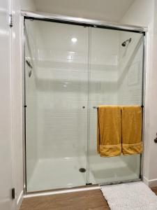 a shower with a glass door in a bathroom at Nimitz Crossing Luxury Residences in San Diego