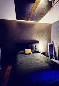 a bedroom with a black bed with a blue light at NUESTRA SEÑORA DEL PINAR 