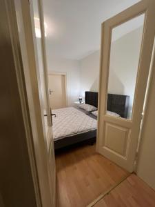 Dormitorio pequeño con cama y espejo en Schöne 2 Zimmer Wohnung in Lübeck en Lübeck