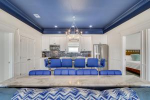 a dining room with blue chairs and a kitchen at Long Beach Home with Views and On-Site Beach Access! in Long Beach