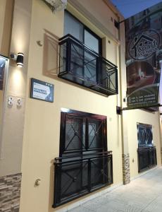 a building with black iron doors and windows at Apart Avenida in Concordia