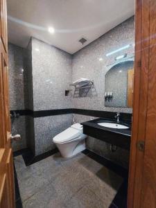 a bathroom with a toilet and a sink at Twins Hotel in Ho Chi Minh City