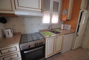 a small kitchen with a stove and a sink at Holidayhome Melodia in Denia