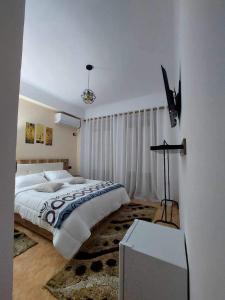 a bedroom with a large bed in a room at Godard Apartments in Vlorë