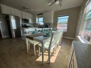 a dining room with a table and chairs in a kitchen at Private beach access -360 Water Views - Upscale home - Second Row in Surfside Beach