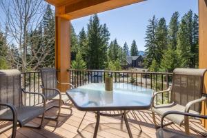 a patio with a table and chairs on a deck at Suncadia Trailhead 1 Pet Friendly Condo 205 in Cle Elum