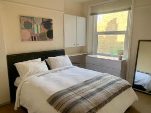 a bedroom with a large bed and a window at Charming london flat in London