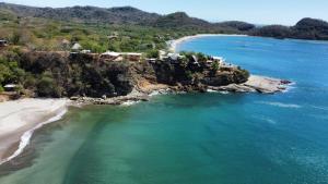 an aerial view of a beach next to the ocean at Cozy Surf Studio in Gigante in Tola