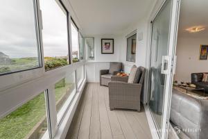a living room with large windows and a couch at Shoreline Suite by Grandeur Property in Southbourne