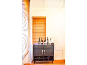 a room with a counter with bottles of wine at River Birches in Turangi