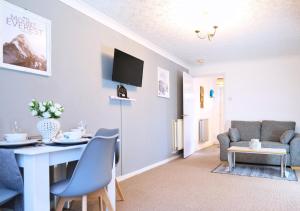 a living room with a dining room table and a couch at Central Peaceful Home with Parking, Wi-Fi and Garden in Stafford