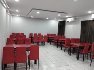 a conference room with red chairs and tables at فندق النسور اجياد in Ajyad