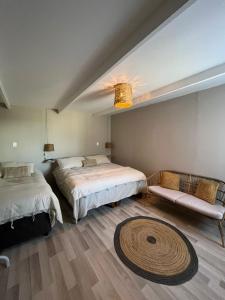 a bedroom with two beds and a rug at Casa Andes in San Pedro de Atacama