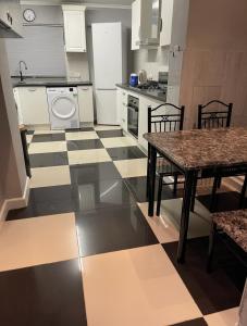 a kitchen with a black and white checkered floor at London Guest Room in London