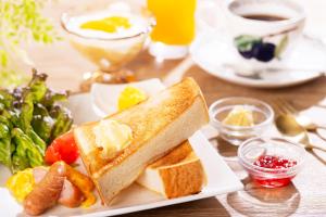 a plate of food with toast and vegetables on a table at City Hotel Air Port in Prince in Izumi-Sano