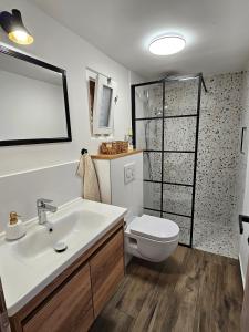 a bathroom with a white sink and a toilet at Apartments by the sea Rogoznica - 22448 in Rogoznica