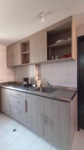 a kitchen with a sink and a counter top at Apartamentos Flowers House in Valledupar