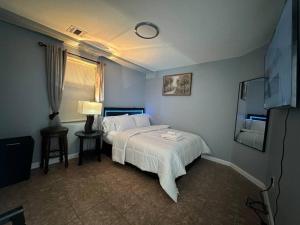 a bedroom with a white bed and a window at Luxury 2-Bedrooms 2-Bathrooms Near NYC/EWR in Newark