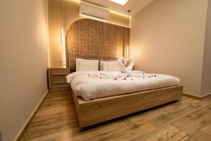 a bedroom with a bed with a swan decoration on it at Royal Great Pyramid INN in Cairo