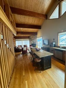 a kitchen and living room with a large island in a house at Mountain Summit Serenity Aspen Views Adventure in Aspen