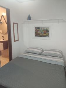 Ένα ή περισσότερα κρεβάτια σε δωμάτιο στο Kit Apto Aconchegante na praia do forte