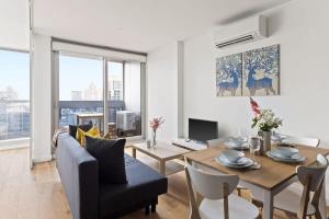 sala de estar con mesa y comedor en A Comfy 2BR Apt w City Views Near Southern Cross en Melbourne