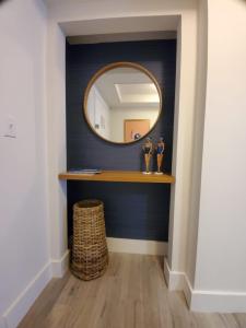 a hallway with a mirror on a blue wall at Cute 1 bedroom unit located in Condo Hotel in the heart of Coconut Grove Free Parking in Miami
