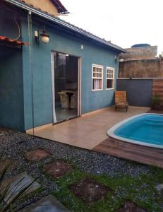 une terrasse avec une piscine à côté d'une maison dans l'établissement Vilarejo do aconchego, à Santa Cruz de Minas