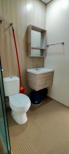 a bathroom with a toilet and a sink at Camelia youth city nilai studio residence 5 pax. in Nilai