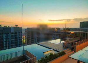 a view of a building with a pool on the roof at Camelia youth city nilai studio residence 5 pax. in Nilai