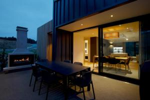 a dining room with a table and a fireplace at Station Bay Lodges - The Retreat in Lake Tekapo