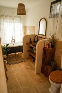 a bathroom with a tub and a toilet and a sink at Maison 47m2 à 10min des plages - billard, baby, salle de sport, jardin in Ajaccio