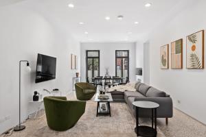 a living room with a couch and chairs at Chelsea Canvas II by RoveTravel Large 3BR Duplex in New York