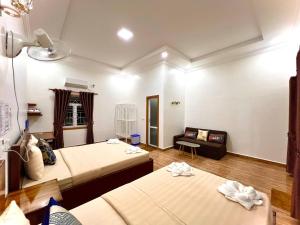 Habitación con 2 camas y sofá en Chomkatae Bungalows en Sen Monorom