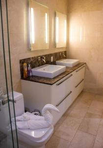 a bathroom with a toilet and a sink at Canal Front Comfort (Dock slip available) in Freeport