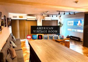 an american vintage room with a large wooden table at Stay Hakata in Fukuoka