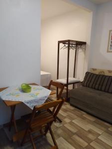 een woonkamer met een tafel en een bank bij Hospedaria Ilhéus 04 in Ilhéus