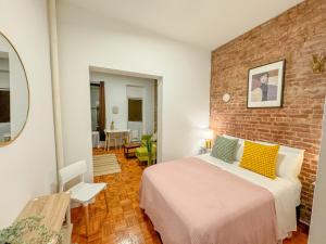 ein Schlafzimmer mit einem Bett und einer Ziegelwand in der Unterkunft 1727-1RN 1Br with A shared Patio - UES in New York