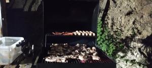 a grill with a bunch of chickens cooking on it at Villa del sueño in Olaya