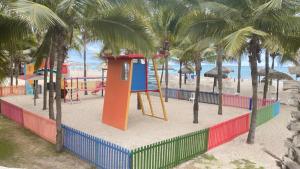 a playground on the beach with palm trees at Punta Centinella Yacht Club in Santa Elena
