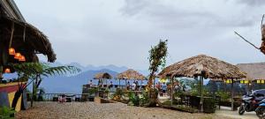 a group of straw umbrellas on a beach at Pu Luong May Home & Cafe in Làng Bang