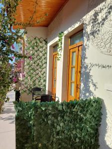 a house with a wooden door and a table at Godard Apartments in Vlorë