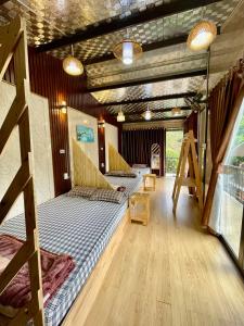 a room with three beds and a balcony at Lake view homestay in Pleiku