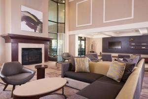 a living room with a couch and a fireplace at Courtyard Greenville-Spartanburg Airport in Greenville