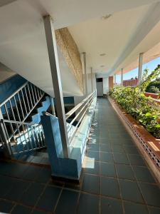 un corridoio dell'edificio con scale mobili e piante di Apartamento en Tucacas a Tucacas